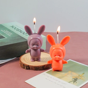 Detailed view of rabbit-ear sleep baby scented candles on a wooden base