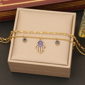 Double-layered gold stainless steel necklace with Hamsa hand and blue Evil Eye pendants
