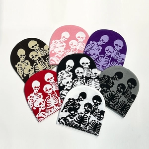 Close-up of multicolored knitted beanies featuring skull patterns in various vibrant colors
