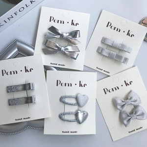 Silver bow and heart hair clips set on display cards for girls elegant hair styling