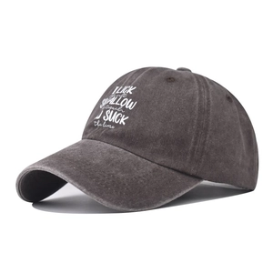 Close-up of washed cotton baseball cap featuring vintage gray texture and white slogan print