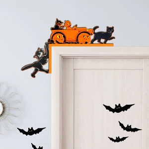 Close-up of Halloween door corner decor featuring black cat and pumpkin carriage silhouette