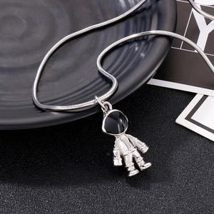 Detail of silver astronaut pendant with black visor on a sleek snake chain necklace