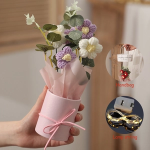 Detail of knitted purple and white flower bouquet in a pink pot with LED lights