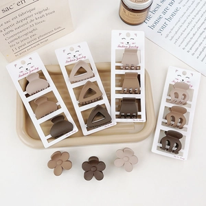 Close-up of matte earth-toned hair clips set in various geometric shapes and brown colors