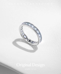 Close-up of s925 silver eternity band ring featuring square light blue gemstones