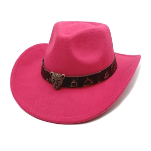Close-up of rose red western cowboy hat with vintage leopard head metal buckle detail