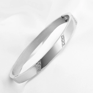 Detailed view of silver 6mm stainless steel bangle with slanted triple diamond accents