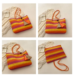 Detail of colorful striped woven tote bag with tassels for beach vacation look