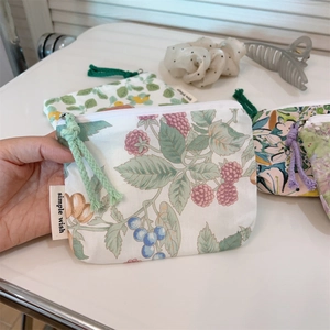 Detail of floral cotton mini coin purse with zipper and simple wish label