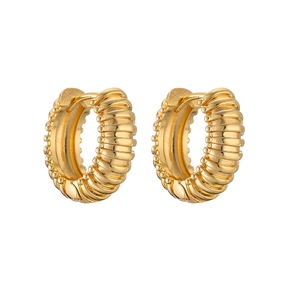 Macro detail of gold plated C-shaped twisted hoop earrings with textured spiral design