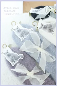 Detail of plush winter socks in four colors with large organza bows and cute cat tags