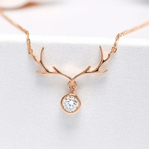 Close-up of rose gold elk antler necklace with a sparkling round cubic zirconia pendant