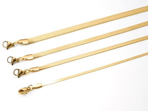 Detail view of four gold stainless steel blade chains in varying widths with lobster clasps