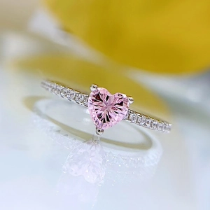 Macro shot of S925 silver ring featuring a pink heart-shaped stone and pavé setting