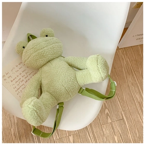 Detail of green frog plush backpack with soft faux lamb wool and adjustable straps