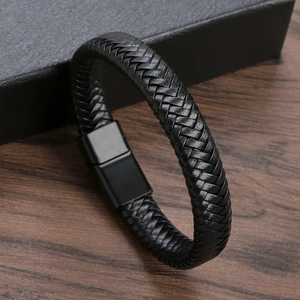 Detailed view of woven black leather strap and matte metal magnetic clasp on men's bracelet