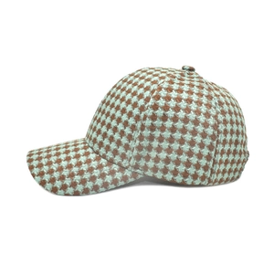 Close-up of brown and mint green houndstooth knit pattern on a baseball cap