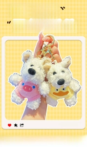 Detail of plush West Highland Terrier keychains in pink pig and yellow duck costumes