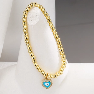 Gold evil eye heart charm bracelet with blue dripping oil and crystal accents