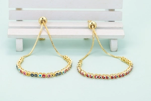 Adjustable gold evil eye bracelet with colorful enamel beads and slider closure