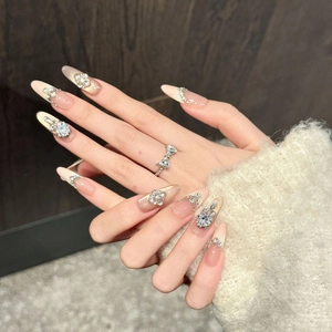 Elegant nude pink and champagne long almond press-on nails with sparkling rhinestones