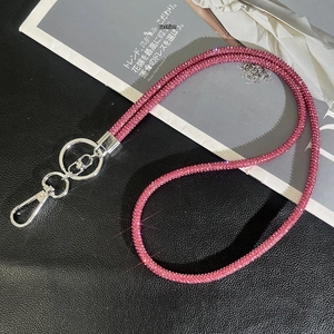 Close-up of sparkling pink rhinestone lanyard with silver metal lobster clasp and ring