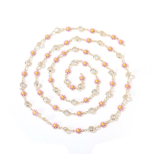 Pink daisy flower and rhinestone necklace with gold plated chain in spiral display
