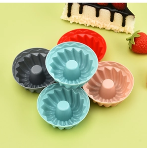 Colorful silicone muffin molds with fluted design and a slice of strawberry cake