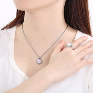 Elegant jewelry set with pearl necklace and matching ring on model in silver finish
