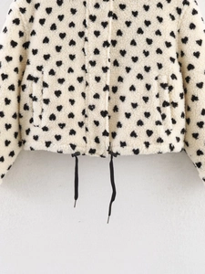 Close-up of fleece heart print jacket featuring an adjustable drawstring hem detail