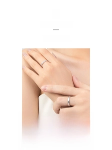 Model wearing a minimalist brushed silver ring set with micro-diamond accents
