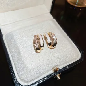 Gold plated C-shaped earrings with double layers of shell and sparkling zircons