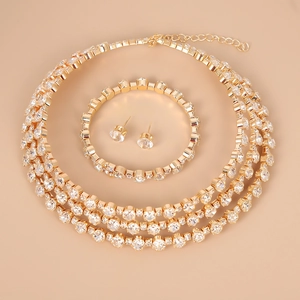 Elegant gold-tone bridal jewelry set with sparkling crystals including necklace and earrings
