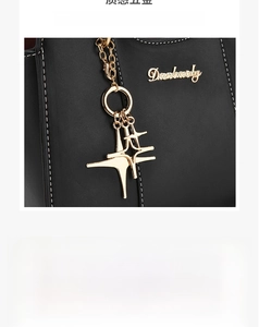 Detailed view of the black lychee pattern leather bag with gold logo and star pendant