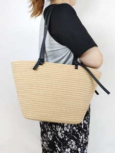 Large beige woven cotton rope tote bag with black slim handles for beach or commute