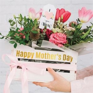 Detail of wooden flower box with Happy Mother's Day gold lettering and pink ribbons