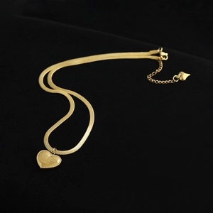 Gold snake chain necklace with heart pendant engraved LOVE you more on black background