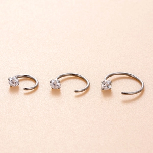 Three minimalist stainless steel C-shaped nose rings with sparkling zircons in various sizes