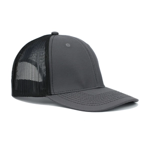 Detail of gray twill cotton visor and black breathable mesh on a classic trucker cap