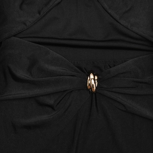 Detail of black cut-out dress featuring a triple gold metal ring hardware accent
