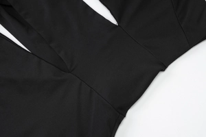 Detail shot of black dress fabric with seamless stitching and smooth texture