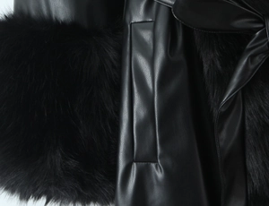 Detailed macro view showing high-quality black faux leather grain and soft fur lining