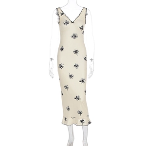 Detail of V-neckline with black wavy ruffles and bow on vintage floral print dress