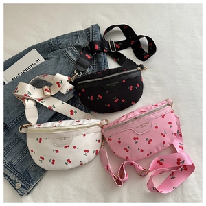 Three leather fanny packs in black, white, and pink featuring cherry prints and wide straps