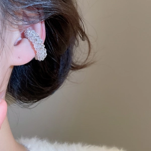 Close-up of a clear beaded ear cuff earring on model showing delicate faceted details
