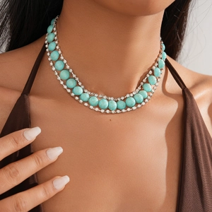 Detail of bohemian double-layered turquoise necklace with sparkling rhinestone borders