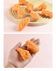 Macro detail of realistic artificial fried chicken wings with golden crispy texture