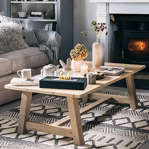 Detailed view of rectangular tabletop ethanol fireplace with real flames on wood table