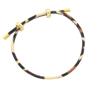 Detail showing leopard print braided cord and sliding gold metal beads on the bracelet